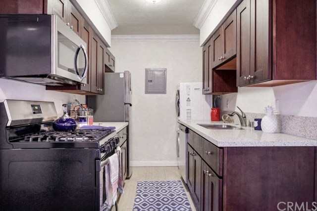 a kitchen with a stove refrigerator and a sink